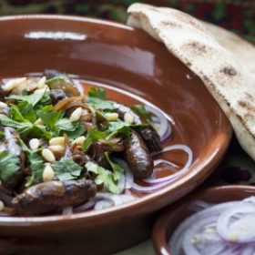 Lebanese Sausages Braised with Pomegranate Molasses and Onions